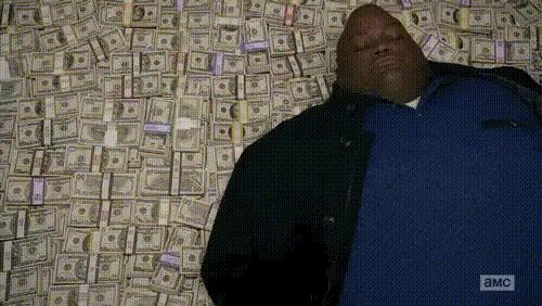 gif of huell from breaking bad laying down in a pallet of money